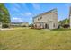 Spacious backyard featuring a well-maintained lawn, a wooden deck, and a sliding glass door at 2429 Follow Me Way, Raleigh, NC 27610