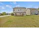 Spacious backyard featuring a well-maintained lawn and a wooden deck with a sliding glass door at 2429 Follow Me Way, Raleigh, NC 27610