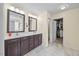 Bathroom featuring a double vanity with sleek cabinets and a walk-in closet at 2429 Follow Me Way, Raleigh, NC 27610