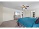 Spacious primary bedroom featuring a ceiling fan, TV, dresser, and walk-in closet at 2429 Follow Me Way, Raleigh, NC 27610