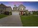 Charming two-story home with a well-manicured lawn, a red door, and an attached two-car garage at 2429 Follow Me Way, Raleigh, NC 27610