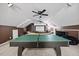 Spacious bonus room featuring a ping pong table, a large projector screen, and a cozy seating area at 2429 Follow Me Way, Raleigh, NC 27610