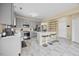 Updated kitchen features gray cabinetry, stainless appliances, eat-in island, and gorgeous marble tile flooring at 2429 Follow Me Way, Raleigh, NC 27610
