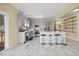 Charming kitchen featuring gray cabinetry, stainless appliances, an eat-in island, and marble tile flooring at 2429 Follow Me Way, Raleigh, NC 27610