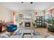 Living room boasts a fireplace, modern decor, lots of plants, hardwood floors, and comfortable seating at 2429 Follow Me Way, Raleigh, NC 27610