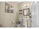 Charming powder room with pedestal sink, decorative mirror, and modern lighting fixtures at 2429 Follow Me Way, Raleigh, NC 27610