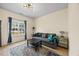 Bright and spacious sitting room with comfortable seating, modern lighting, and a large window at 2429 Follow Me Way, Raleigh, NC 27610