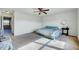 Light filled bedroom featuring a neutral carpet, ceiling fan and ensuite bathroom at 2540 Averon Dr, Fuquay Varina, NC 27526