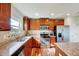 Well-lit kitchen featuring stainless steel appliances, granite countertops, and dark wood cabinetry at 2540 Averon Dr, Fuquay Varina, NC 27526