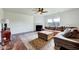 Cozy living room with a fireplace, ceiling fan, hardwood floors and comfortable furniture at 2540 Averon Dr, Fuquay Varina, NC 27526