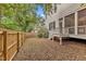 Fenced backyard with a wooden fence, some greenery, and access to a porch at 2615 Bedford Ave, Raleigh, NC 27607