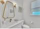 Elegant powder room featuring a gold-framed mirror, modern lighting, and stylish fixtures at 2615 Bedford Ave, Raleigh, NC 27607