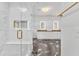 Bright bathroom with tiled shower, dual sinks, vanity, and marble floors and countertops at 2615 Bedford Ave, Raleigh, NC 27607