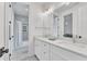 Well-lit bathroom features a double vanity and tile floors, with the shower visible at 2615 Bedford Ave, Raleigh, NC 27607