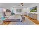 Bedroom with ceiling fan, wall art, television and upholstered furniture at 2615 Bedford Ave, Raleigh, NC 27607