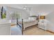 Cozy bedroom with a ceiling fan, large window and a nightstand with lamp at 2615 Bedford Ave, Raleigh, NC 27607