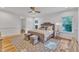 Sun-filled bedroom with a ceiling fan, natural light, and wood floors at 2615 Bedford Ave, Raleigh, NC 27607