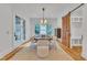 Bright dining room featuring modern chandelier, large windows, and a rustic barn door at 2615 Bedford Ave, Raleigh, NC 27607