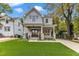 Charming two-story home featuring a welcoming front porch, manicured lawn, and beautiful stone accents at 2615 Bedford Ave, Raleigh, NC 27607