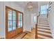 Bright foyer featuring hardwood floors, stylish lighting, and a staircase at 2615 Bedford Ave, Raleigh, NC 27607