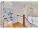 Hallway with hardwood floors and white railings leading to another room at 2615 Bedford Ave, Raleigh, NC 27607