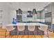 Modern kitchen with a large island, pendant lighting, and seating for four at 2615 Bedford Ave, Raleigh, NC 27607