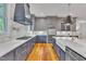 A gorgeous kitchen featuring custom cabinets, marble backsplash, stainless appliances, and a large island at 2615 Bedford Ave, Raleigh, NC 27607