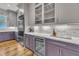 Kitchen area showing a wine fridge and stainless refrigerator, next to glass-front cabinets with decor lighting at 2615 Bedford Ave, Raleigh, NC 27607