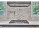 Kitchen range features a designer hood, marble backsplash, pot filler, and a high-end cooktop at 2615 Bedford Ave, Raleigh, NC 27607