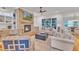 Spacious living room featuring a brick fireplace and large windows with natural light at 2615 Bedford Ave, Raleigh, NC 27607