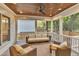 Inviting screened porch with cozy wicker furniture, wood ceiling, and ceiling fan at 2615 Bedford Ave, Raleigh, NC 27607