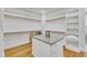 Spacious walk-in closet with center island, wood floor, and ample built-in shelving at 2615 Bedford Ave, Raleigh, NC 27607