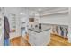 Well-organized closet featuring a central island, wooden floors, and extensive shelving units at 2615 Bedford Ave, Raleigh, NC 27607