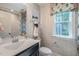 Stylish bathroom features patterned wallpaper and window with elegant roman shade at 269 Ivy Ridge Rd, Chapel Hill, NC 27516