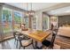 Bright dining area with a wooden table, stylish chairs, and large windows offering scenic backyard views at 269 Ivy Ridge Rd, Chapel Hill, NC 27516