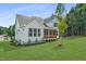 Back exterior view of a home featuring a screened-in porch and lush green lawn at 269 Ivy Ridge Rd, Chapel Hill, NC 27516