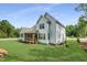 Back exterior view of home featuring a screened-in porch and beautifully maintained lawn at 269 Ivy Ridge Rd, Chapel Hill, NC 27516
