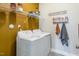 Functional laundry room equipped with a washer, dryer, shelving, and neutral wall decor at 269 Ivy Ridge Rd, Chapel Hill, NC 27516