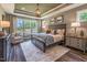 Luxurious main bedroom featuring tray ceilings, hardwood floors, and large windows at 269 Ivy Ridge Rd, Chapel Hill, NC 27516