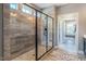 Spacious walk-in shower with light stone colored tiling and glass enclosure at 269 Ivy Ridge Rd, Chapel Hill, NC 27516