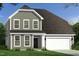 Charming two-story home with gray siding, a dark roof, a two-car garage and a well-manicured lawn at 27 Spring Crest Dr # 69, Angier, NC 27501