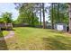 Large backyard features a lush lawn and detached shed for extra storage at 2702 Richwood Rd, Durham, NC 27705