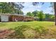 Expansive backyard featuring a lawn, deck, and a classic brick house exterior at 2702 Richwood Rd, Durham, NC 27705
