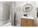 Well-lit bathroom with a shower, vanity, and framed botanical art prints at 2702 Richwood Rd, Durham, NC 27705