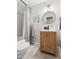 Well-lit bathroom with a shower, vanity, and framed botanical art prints at 2702 Richwood Rd, Durham, NC 27705