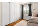 Bedroom featuring closet space, window view, and light beige bedding at 2702 Richwood Rd, Durham, NC 27705