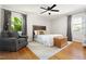 Cozy bedroom featuring hardwood floors, neutral walls, and a comfortable armchair at 2702 Richwood Rd, Durham, NC 27705
