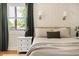 Cozy bedroom with stylish wallpaper, bedside tables, and natural light from the window at 2702 Richwood Rd, Durham, NC 27705