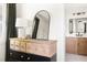 A bedroom dresser and mirror leading to a bathroom with wood vanities at 2702 Richwood Rd, Durham, NC 27705