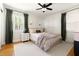 Cozy bedroom with wallpaper, neutral furnishings, and natural light from the large window at 2702 Richwood Rd, Durham, NC 27705